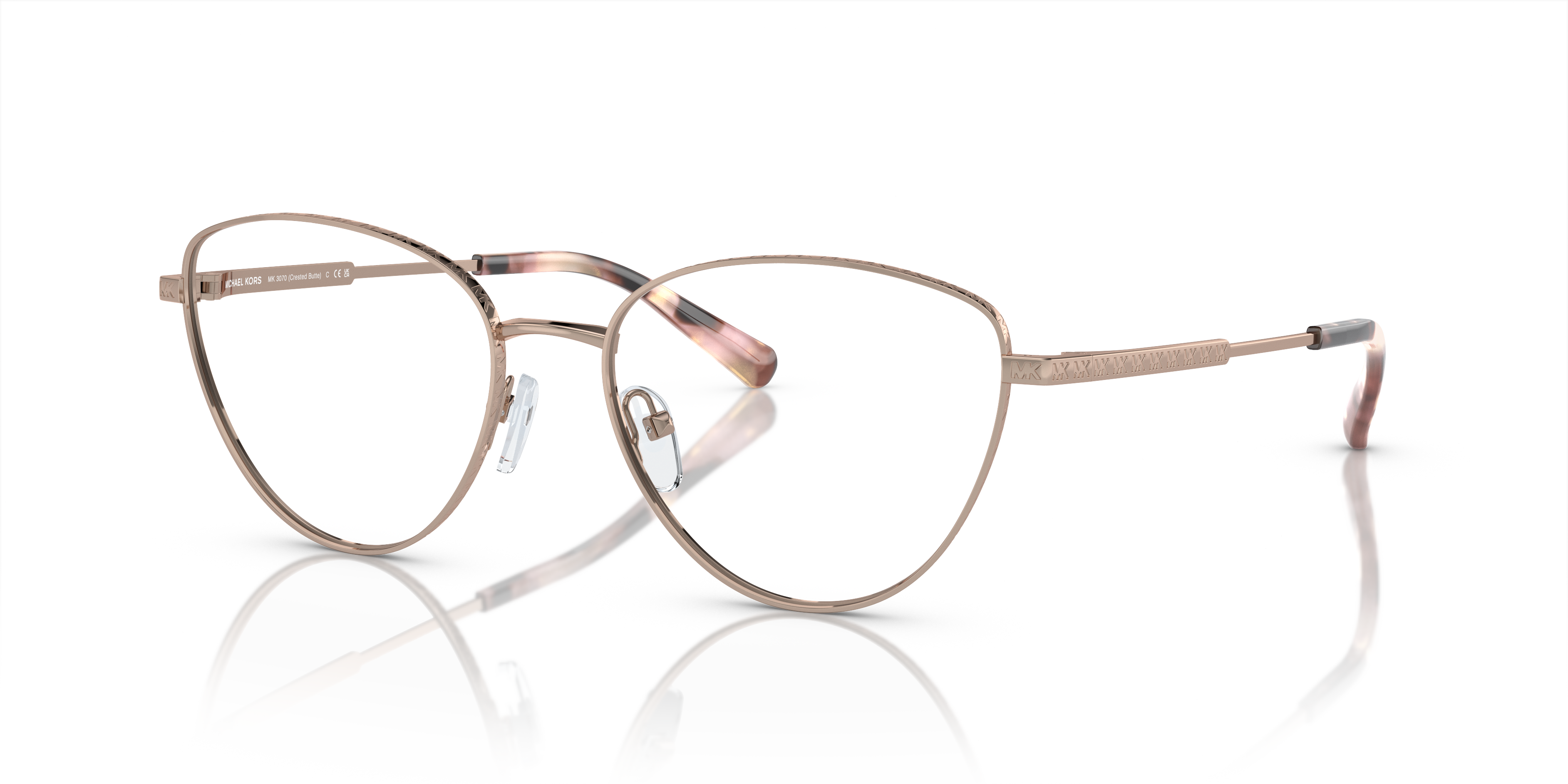 Occhiali da sole Michael Kors donna 0MK3070 CRESTED BUTTE con montatura Rose Gold e lenti grigie sfumate, appoggiati su una s