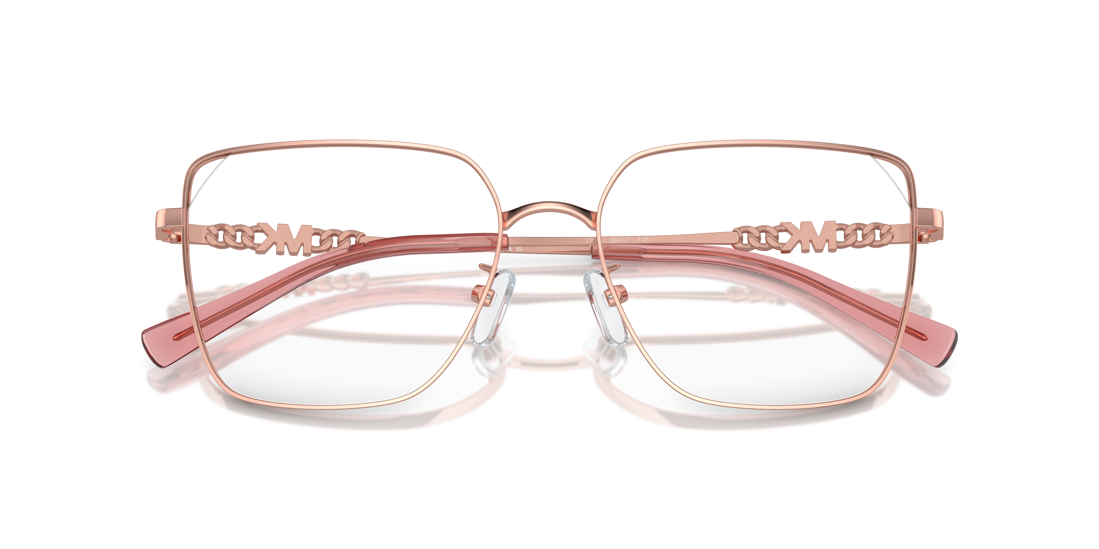 Donna che indossa occhiali da sole Michael Kors DALI Shiny Rose Gold, con montatura in metallo sottile e lenti scure. Primo p