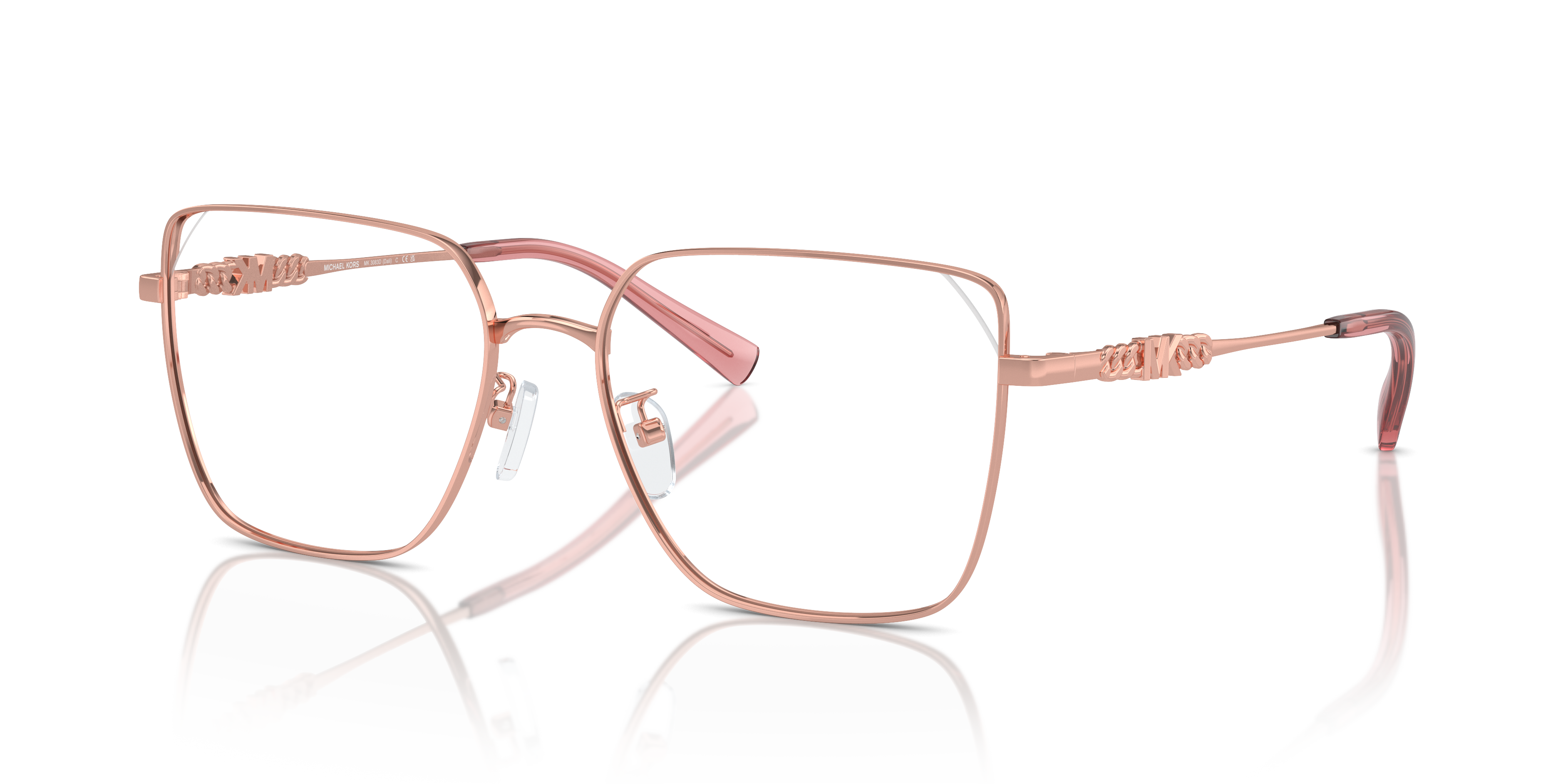 Donna che indossa occhiali da sole Michael Kors DALI Shiny Rose Gold, con montatura in metallo sottile e lenti scure. Primo p