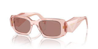 Occhiali da sole Prada PR 17WS Frosted Vanilla donna, montatura color vaniglia chiaro con lenti scure, posti su una superfici