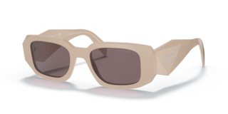 Occhiali da sole Prada PR 17WS Frosted Vanilla donna, montatura color vaniglia chiaro con lenti scure, posti su una superfici