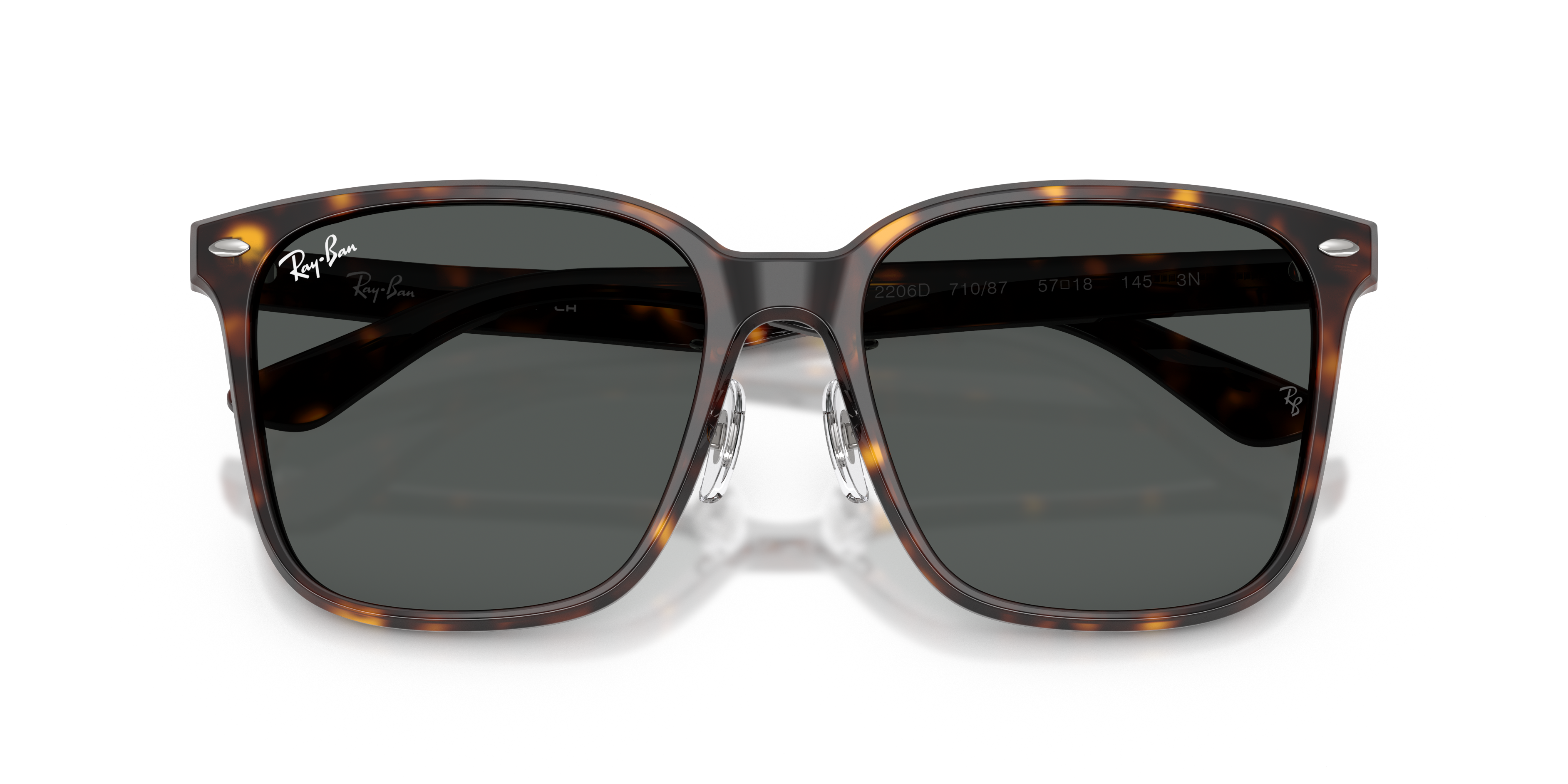 Occhiali da sole Ray-Ban RB2206D con montatura trasparente e lenti scure, posati su una superficie chiara, con astuccio e pan