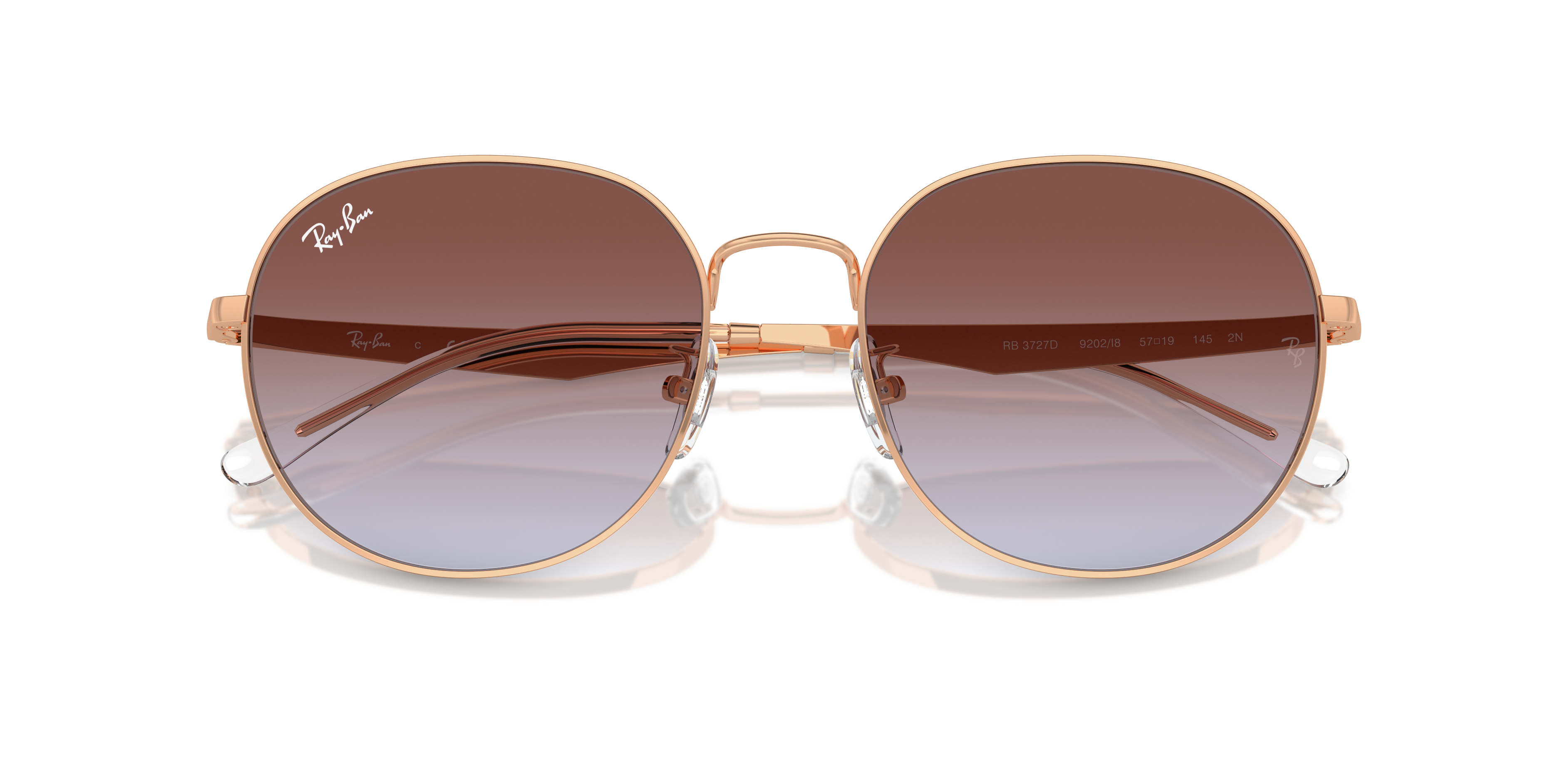 Occhiali da sole Ray-Ban RB3727D neri con montatura in metallo, lenti scure e forma a pilota, poggiati su una superficie chia