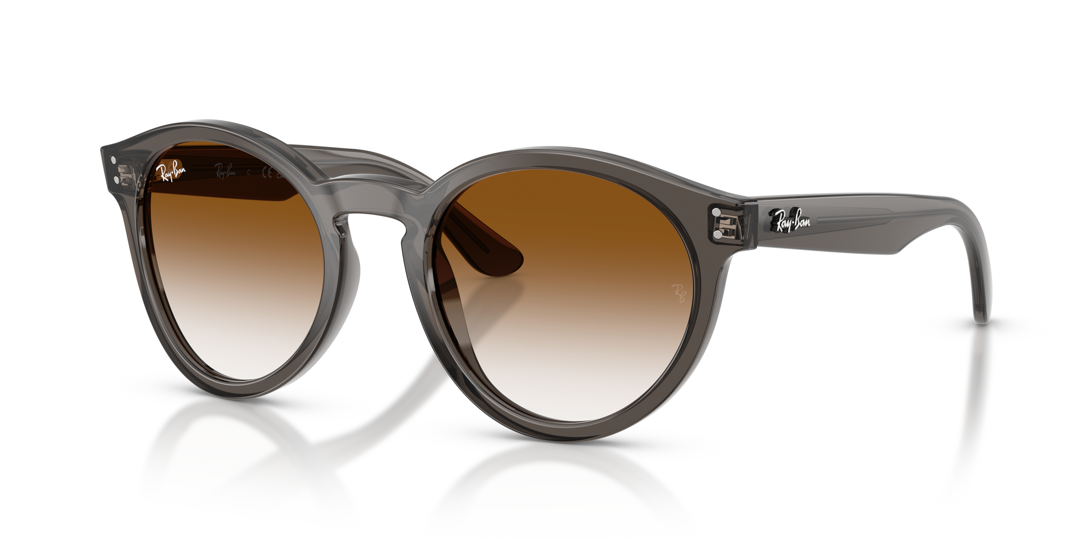 Occhiali da sole Ray-Ban Reverse 0RBR0505S Transparent Dark Grey con lenti invertite, posati su una superficie chiara, mostra