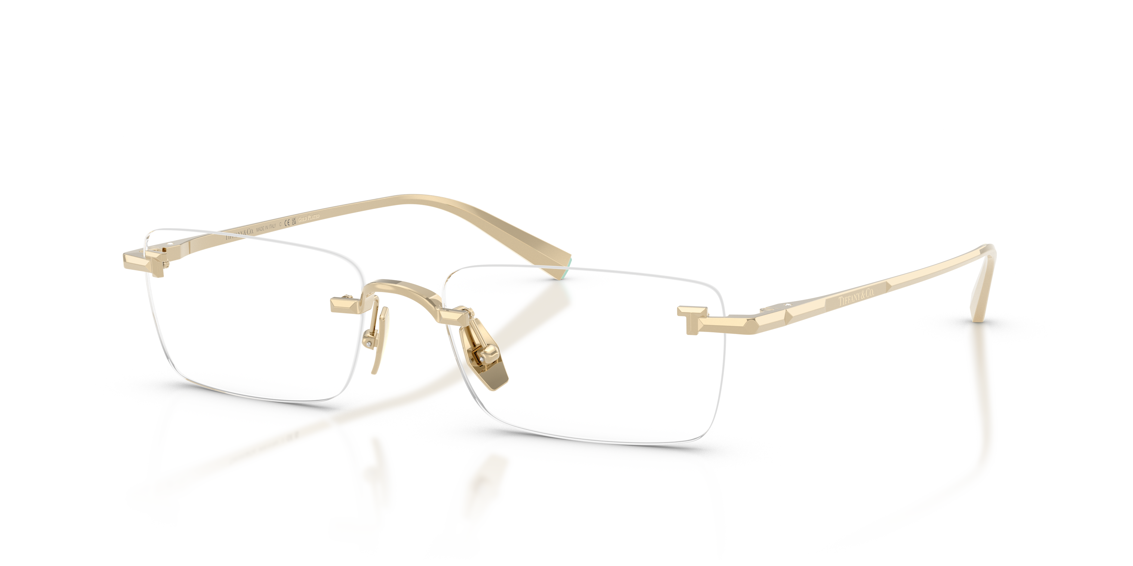 Occhiali da sole Tiffany TF1177KB placcati in oro pallido, mostrati su una superficie chiara, con lenti che riflettono un leg