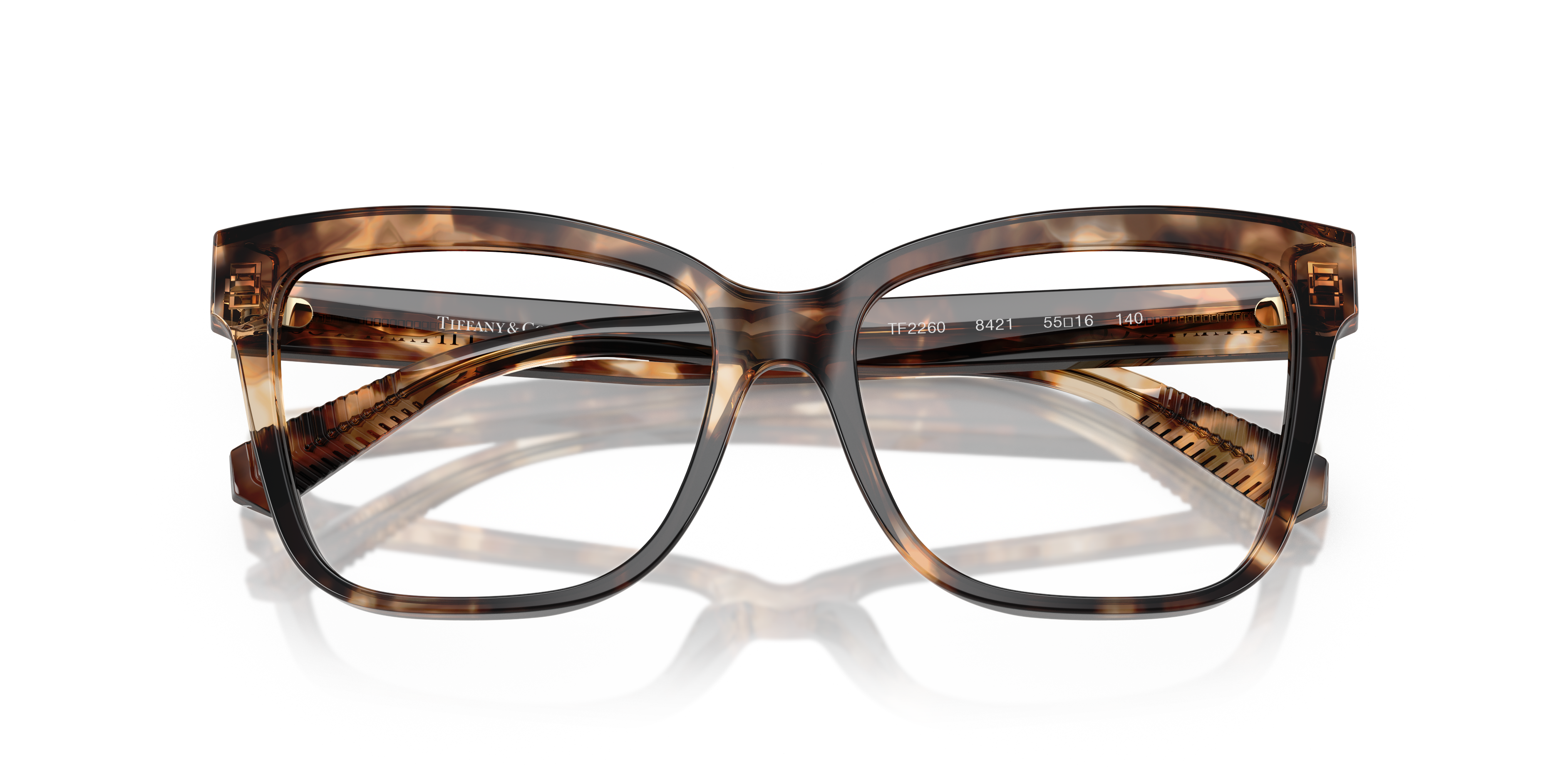 Occhiali da sole Tiffany TF2260 da donna con montatura blu scuro solido e lenti scure, posti su una superficie chiara