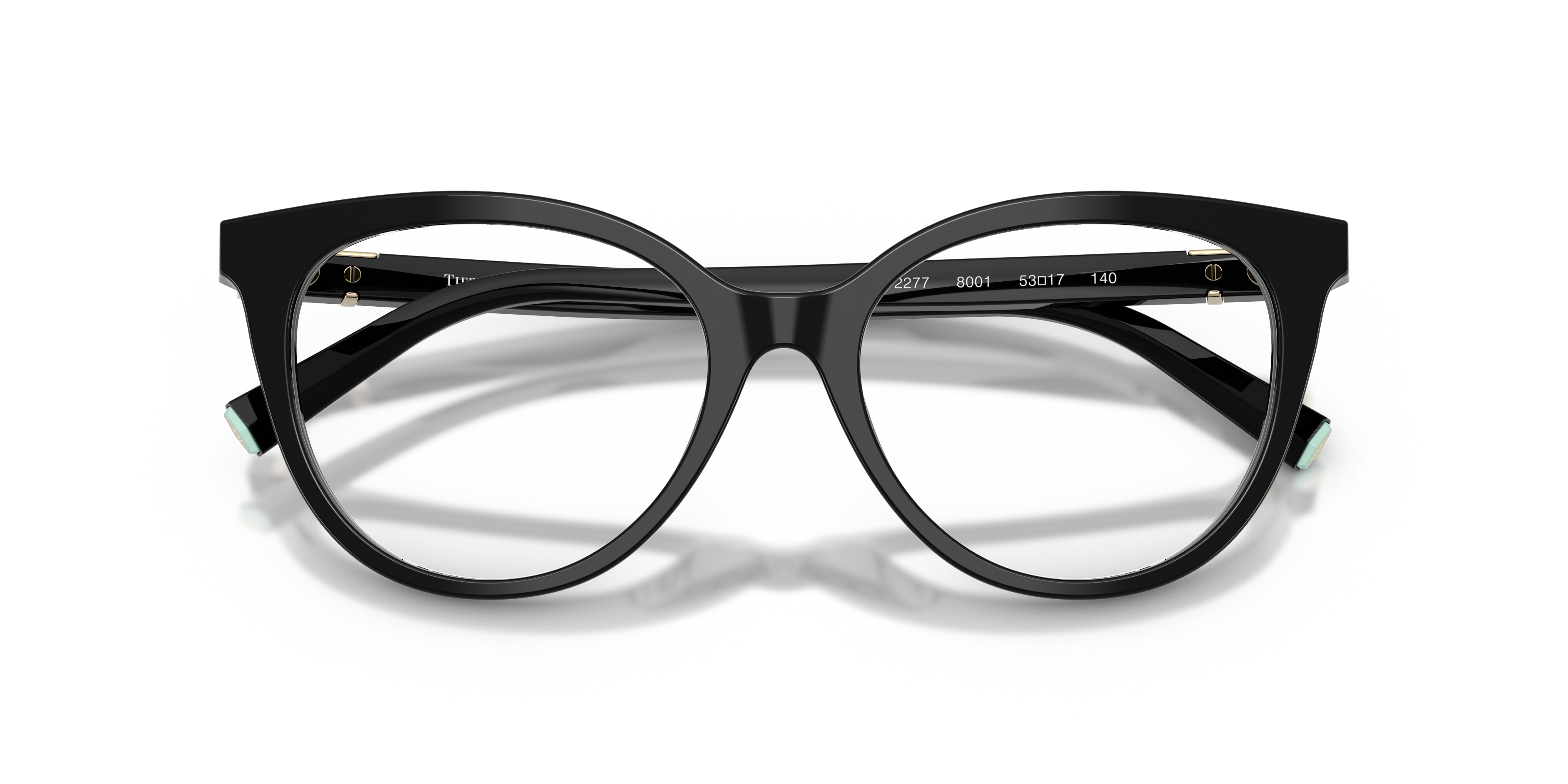 Occhiali da sole Tiffany TF2277 neri con interno aste Tiffany Blue, appoggiati su superficie chiara.