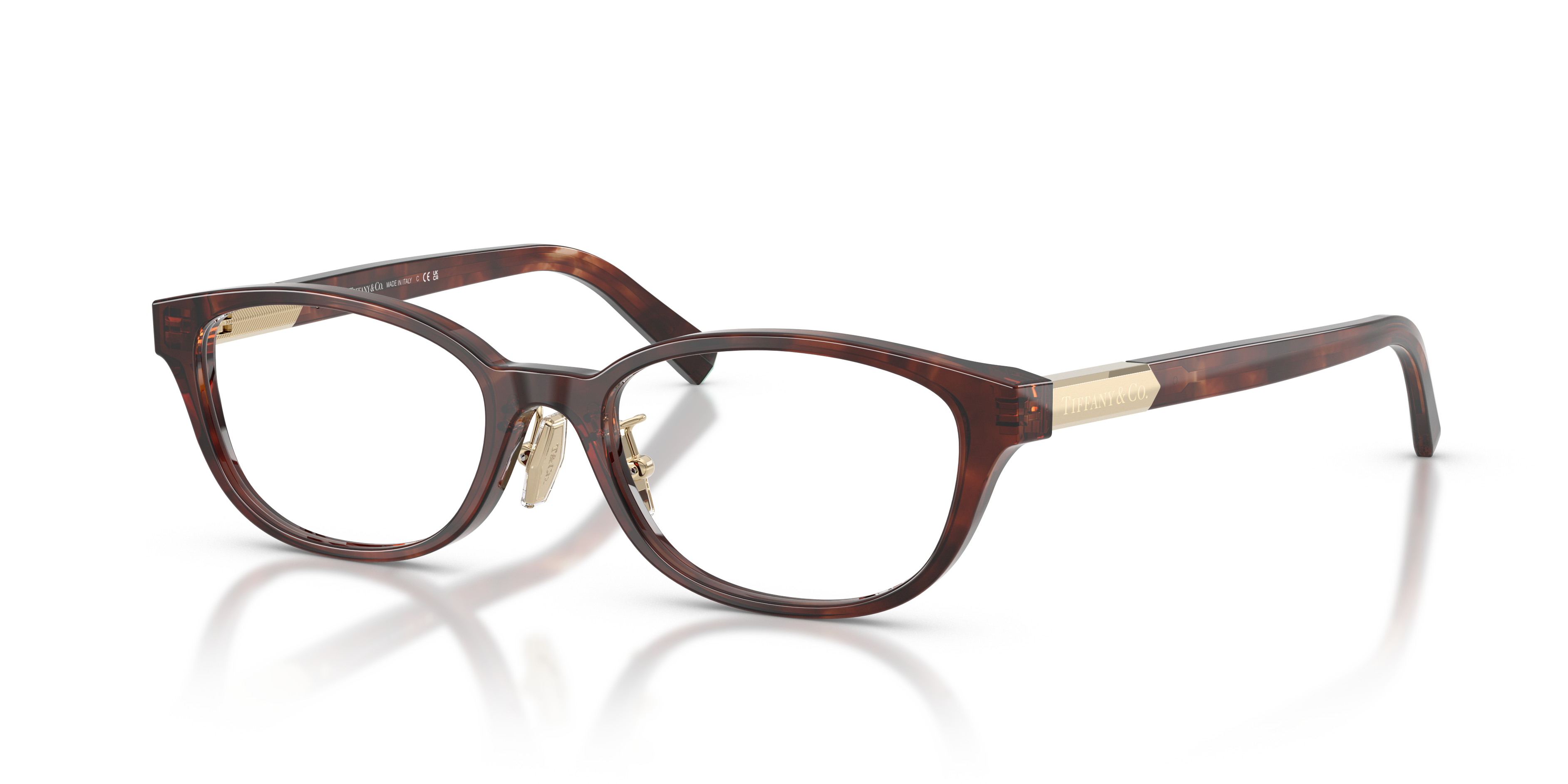 Occhiali da sole Tiffany TF2280D Spotted Brown Havana donna, con montatura in acetato e lenti scure, posti su uno sfondo chia