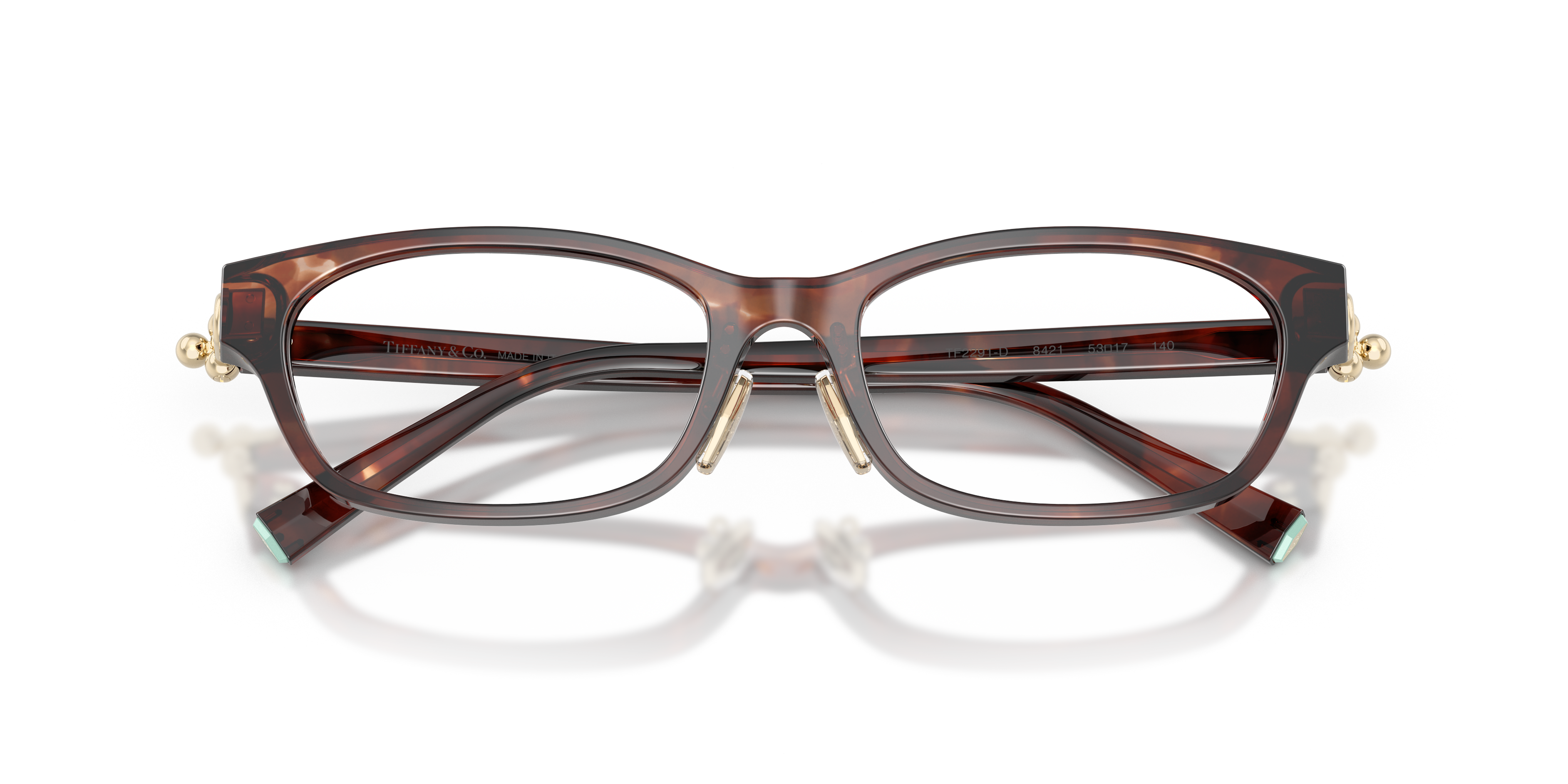 Occhiali da sole Tiffany & Co. modello TF2291D da donna in colore Havana, con montatura elegante e lenti scure, posti su una