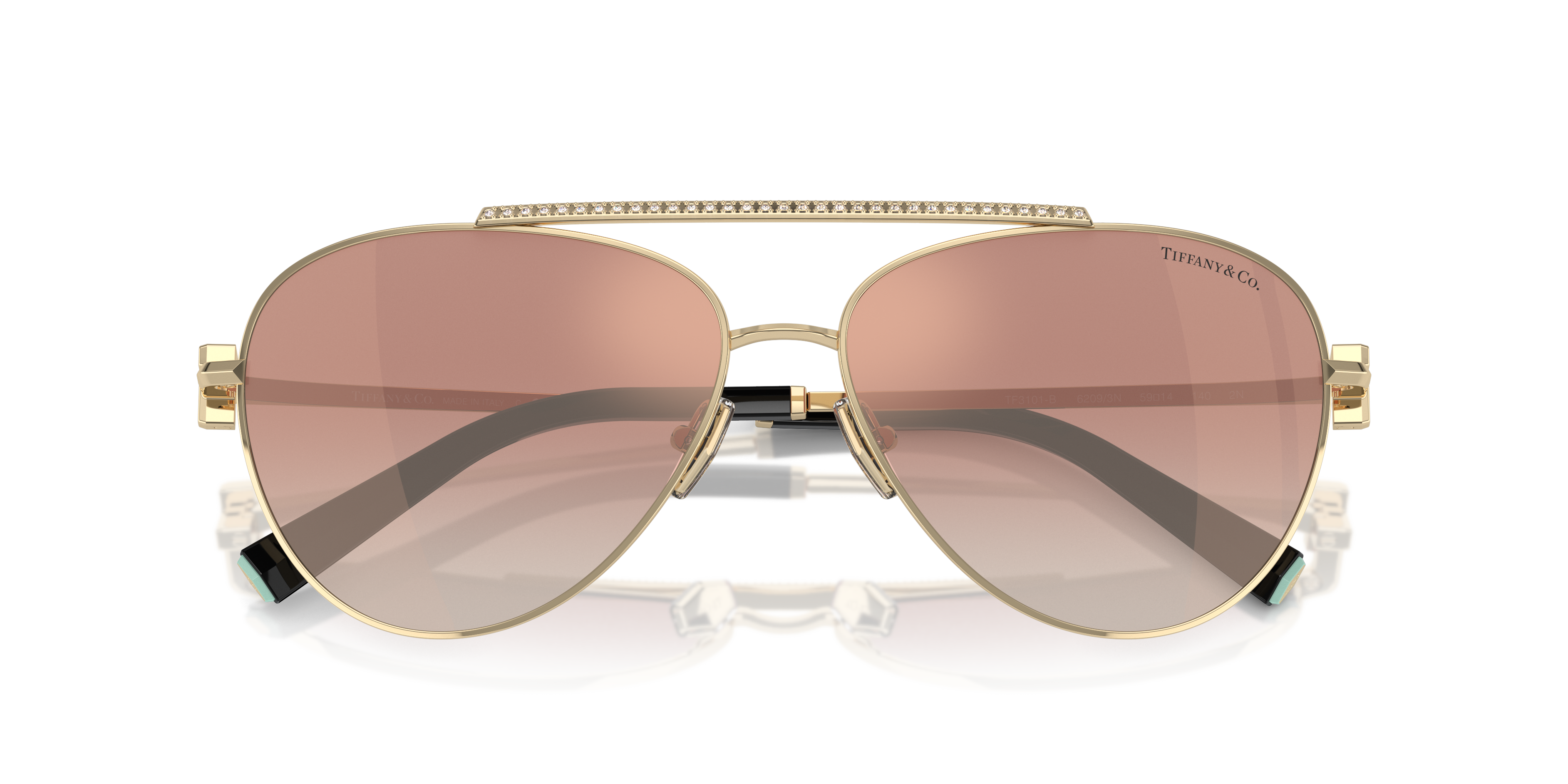 Occhiali da sole Tiffany TF3101B donna di colore argento, con montatura in metallo, poggiati su superficie chiara.