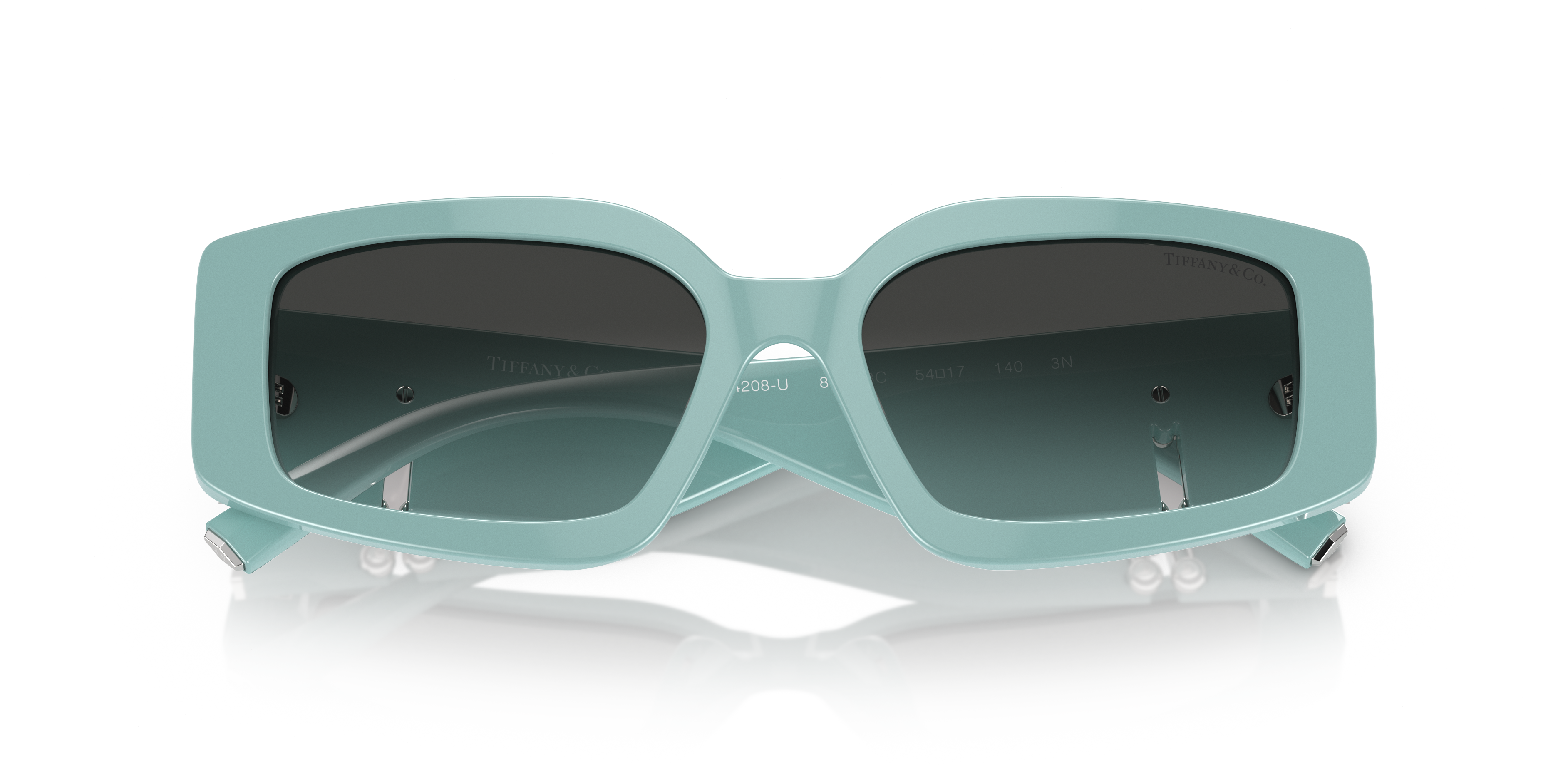 Occhiali da sole Tiffany & Co. modello 0TF4208U neri da donna, montatura cat-eye, appoggiati su superficie chiara.