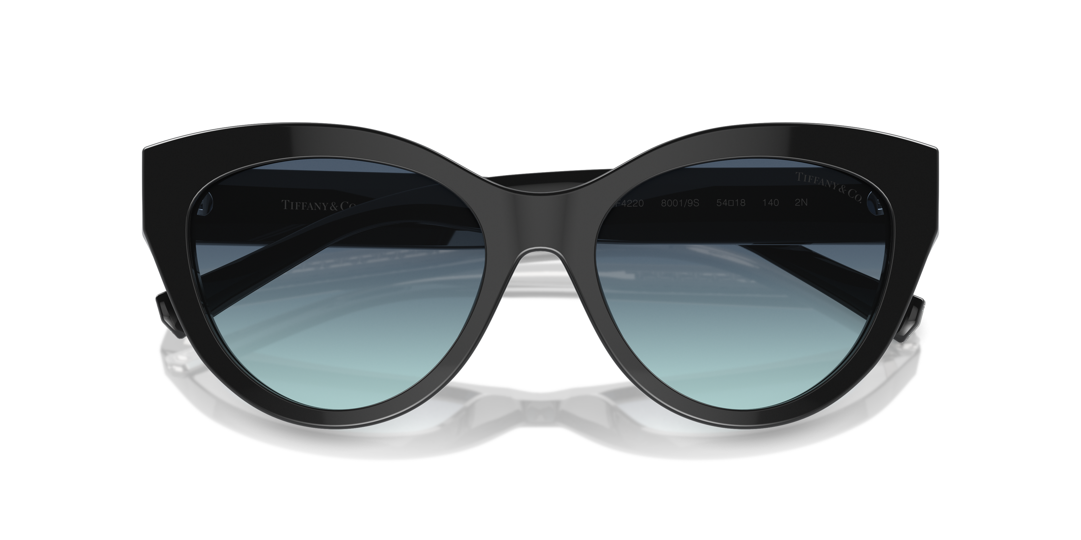Occhiali da sole da donna Tiffany TF4220 Havana appoggiati su una superficie chiara, che mostra la montatura tartarugata e le
