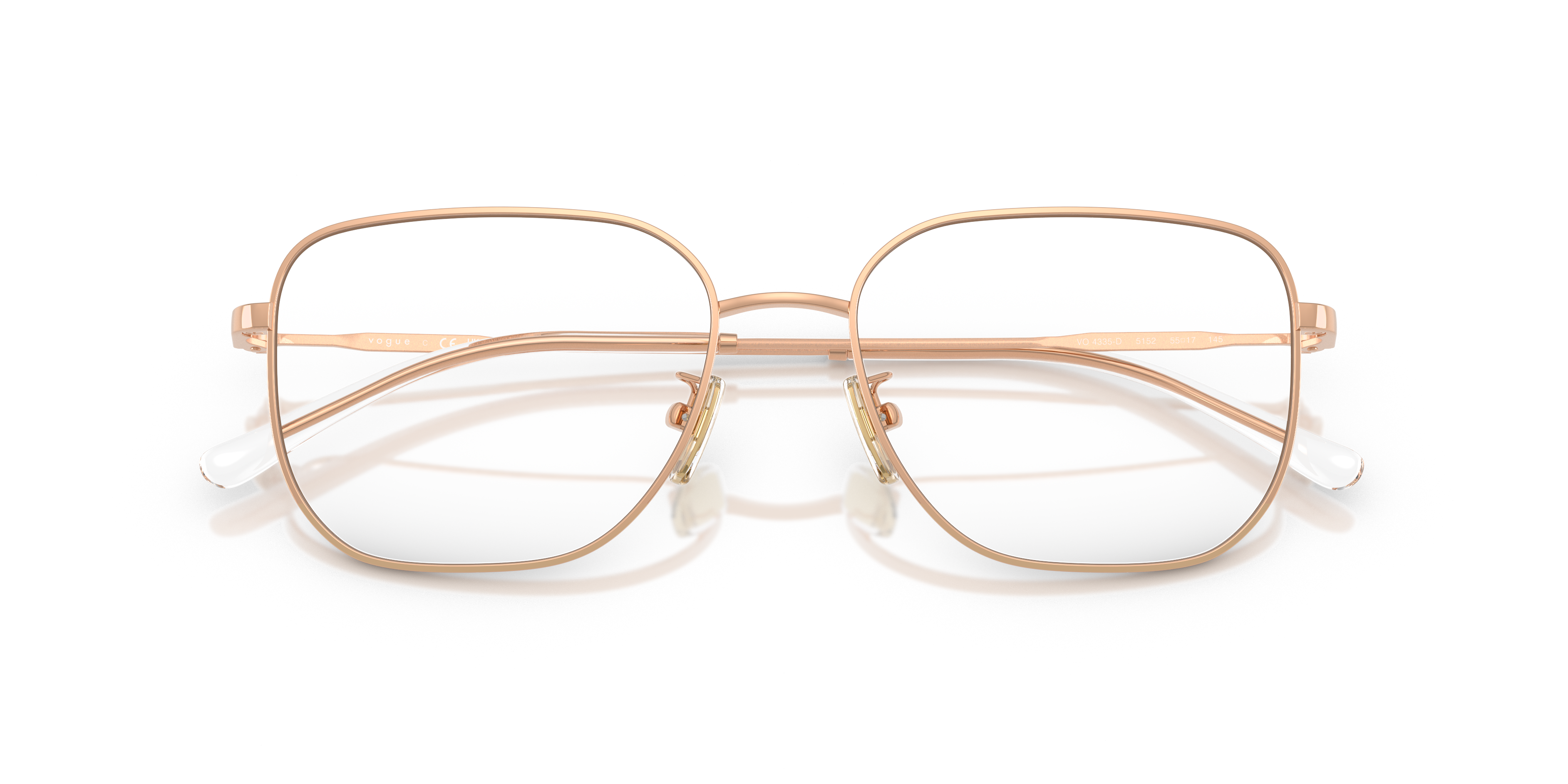 Occhiali da sole donna Vogue 0VO4335D con montatura marrone chiaro e lenti sfumate, posati su una superficie chiara.