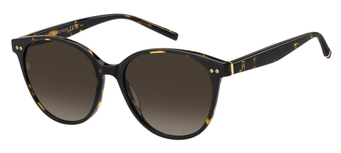 Occhiali da sole donna Tommy Hilfiger TH 2289/S color avana, montatura squadrata con lenti scure, posti su una superficie chi
