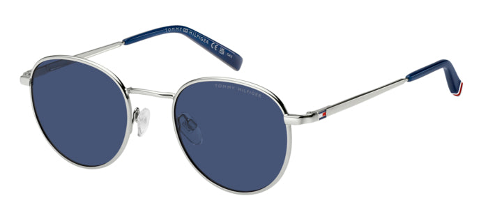 Occhiali da sole Tommy Hilfiger TH 2217/S con montatura metallica dorata, lenti scure e aste sottili, posizionati su una supe