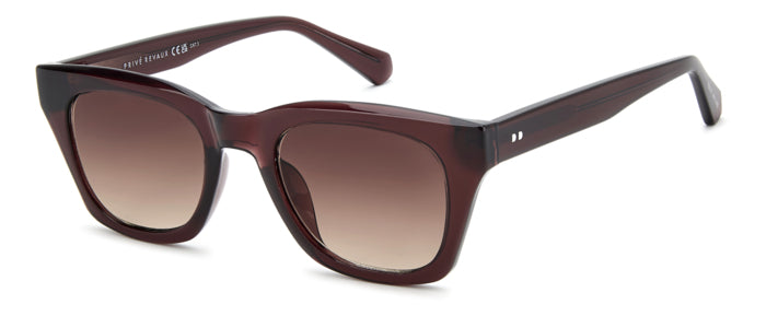 Occhiali da sole Privé Revaux modello 208928 (PR3009/G/S) da donna, montatura color avana e lenti scure, posti su una superfi